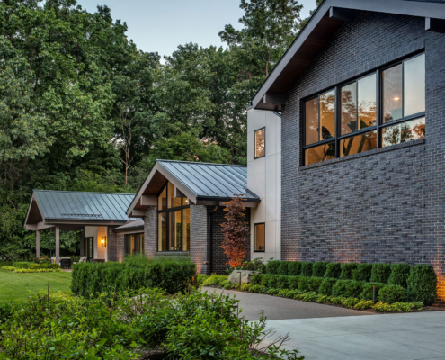 Protruding brickwork provides an artistic touch to the contemporary charcoal wall color